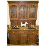 A pine dresser, three short drawers over three cupboards,