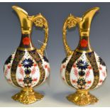 A pair of Royal Crown Derby solid gold band, Imari 1128 pattern swan necked ewer vases,