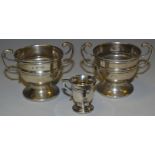 A pair of George V silver miniature trophy cups, Chester 1915; a miniature tyg,