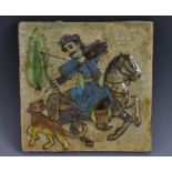 A Qajar fritware square tile, the centre moulded in high relief and and decorated in underglaze,