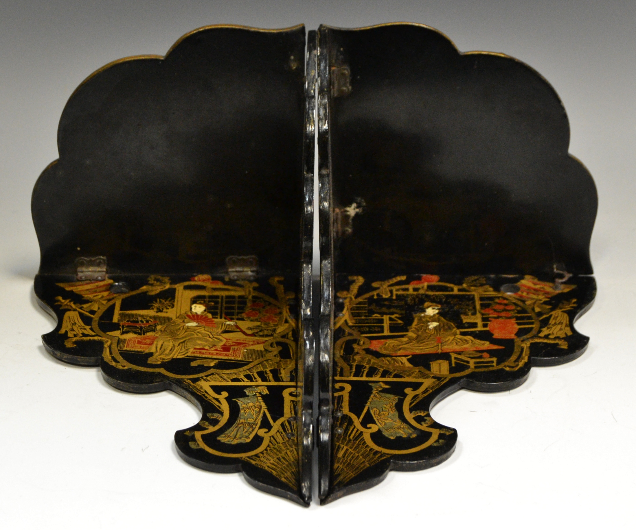 A pair of early 20th century Japanese black lacquer folding wall shelves,