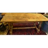 A 19th century pine Derbyshire pine planked topped kitchen table, turned supports,