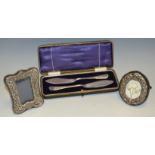 A miniature silver easel photograph frame; another oval;