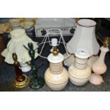Lighting - a pair of tan and cream banded table lamps; a teak table lamp,