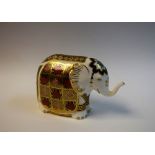 A Royal Crown Derby paperweight, Elephant, raised trunk, gold stopper, 15cm wide, printed marks,