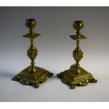 A pair of ornate Victorian brass candlesticks
