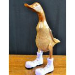 A novelty carved wooden duck, Lilac Boots,