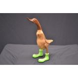 A novelty carved wooden duck, Green Boots,