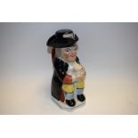 A 19th century toby jug and cover, as a snuff taker,