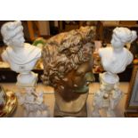 A painted plaster bust of Apollo, 51cm high; a pair of ceramic busts,