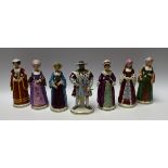 A set of seven continental porcelain figures, Henry VIII and his six wives, picked out in colour,