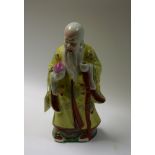 A Chinese Republican Period porcelain figure, of Shou Lao, typically modelled holding a peach,