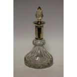 A cut glass scent bottle, silver collar, prismatic stopper, indistinct marks, c.