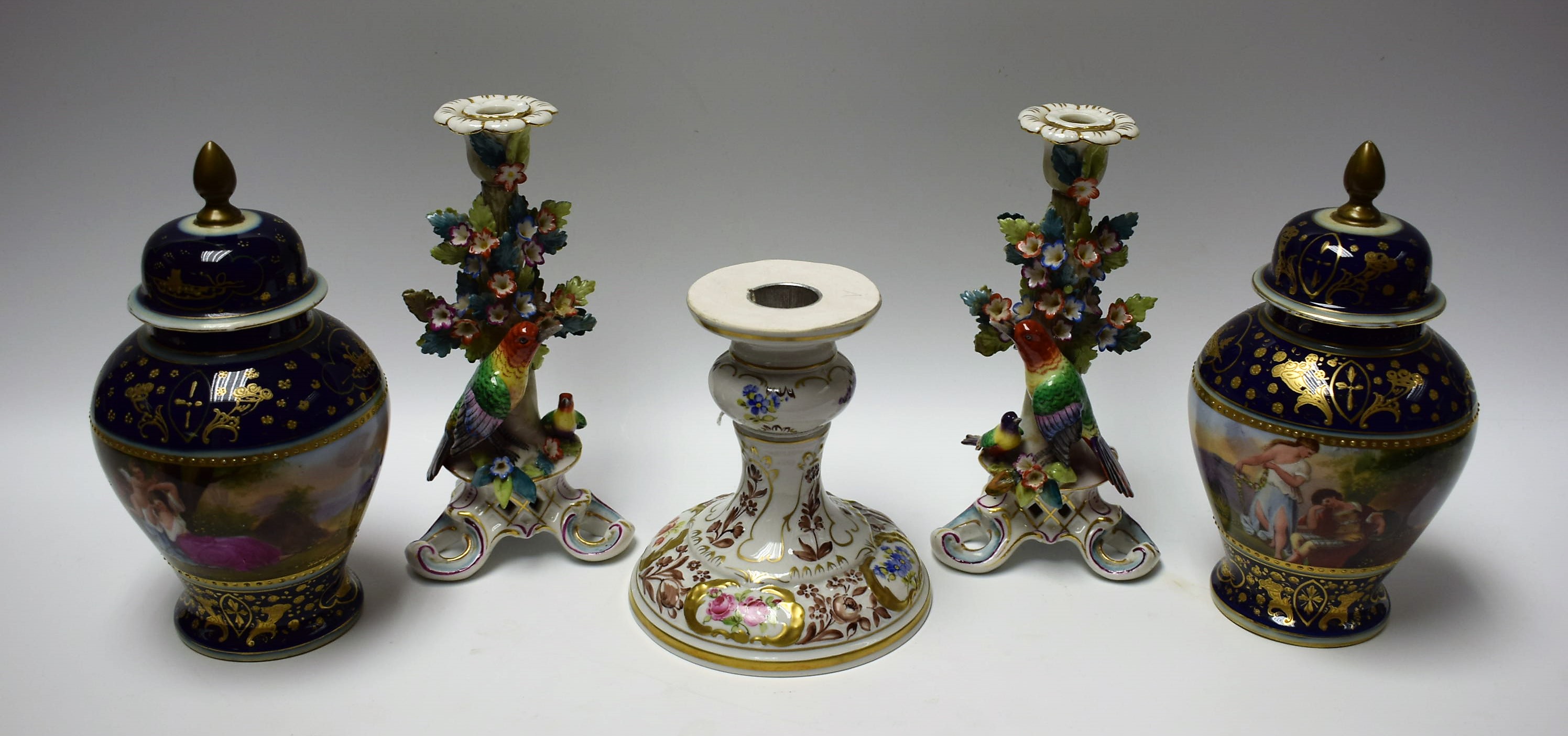 Ceramics - a pair of Dresden style candlesticks with hand painted fanciful birds perched at the