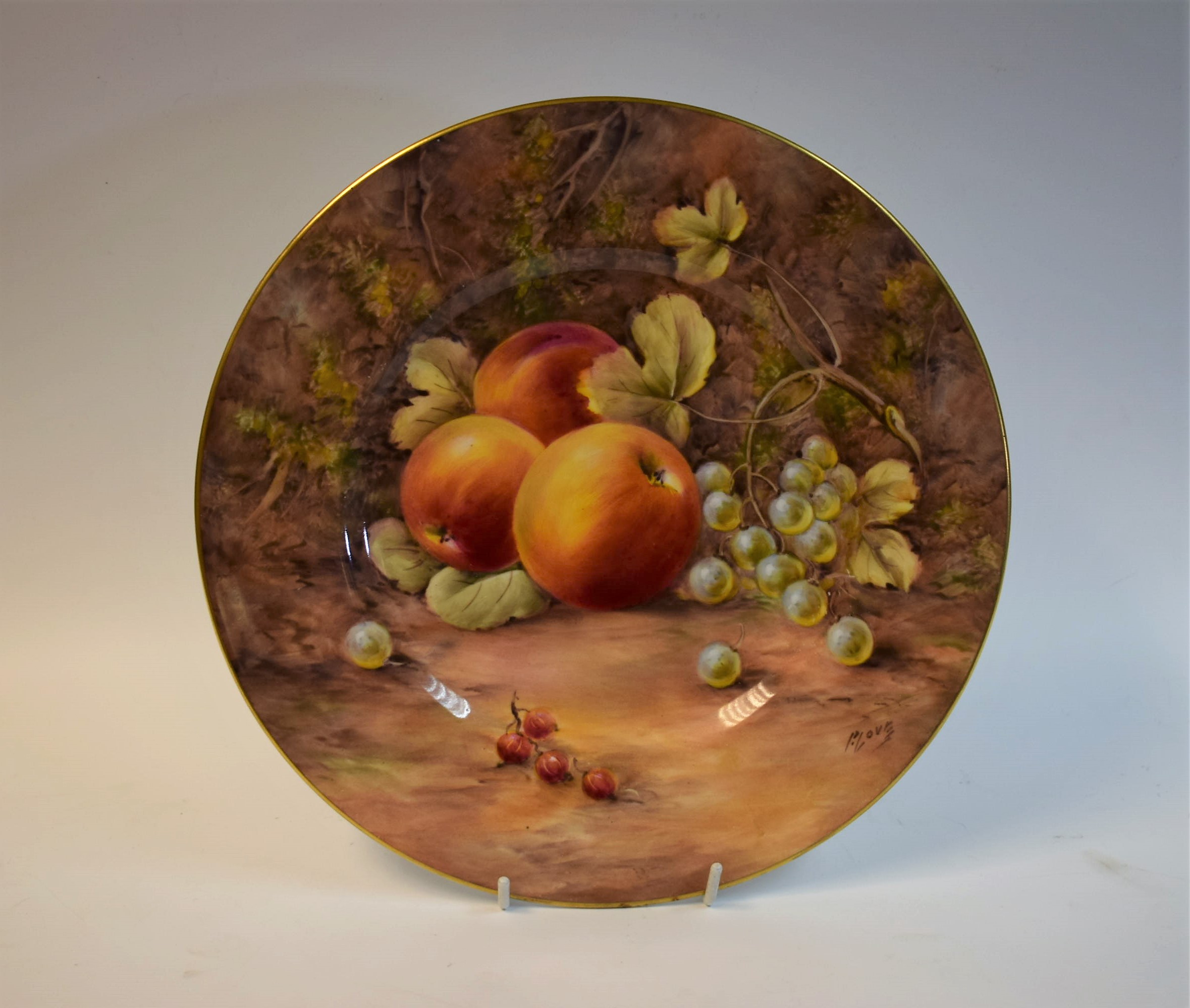 A Royal Worcester shaped circular plate, painted by Peter Love, signed,