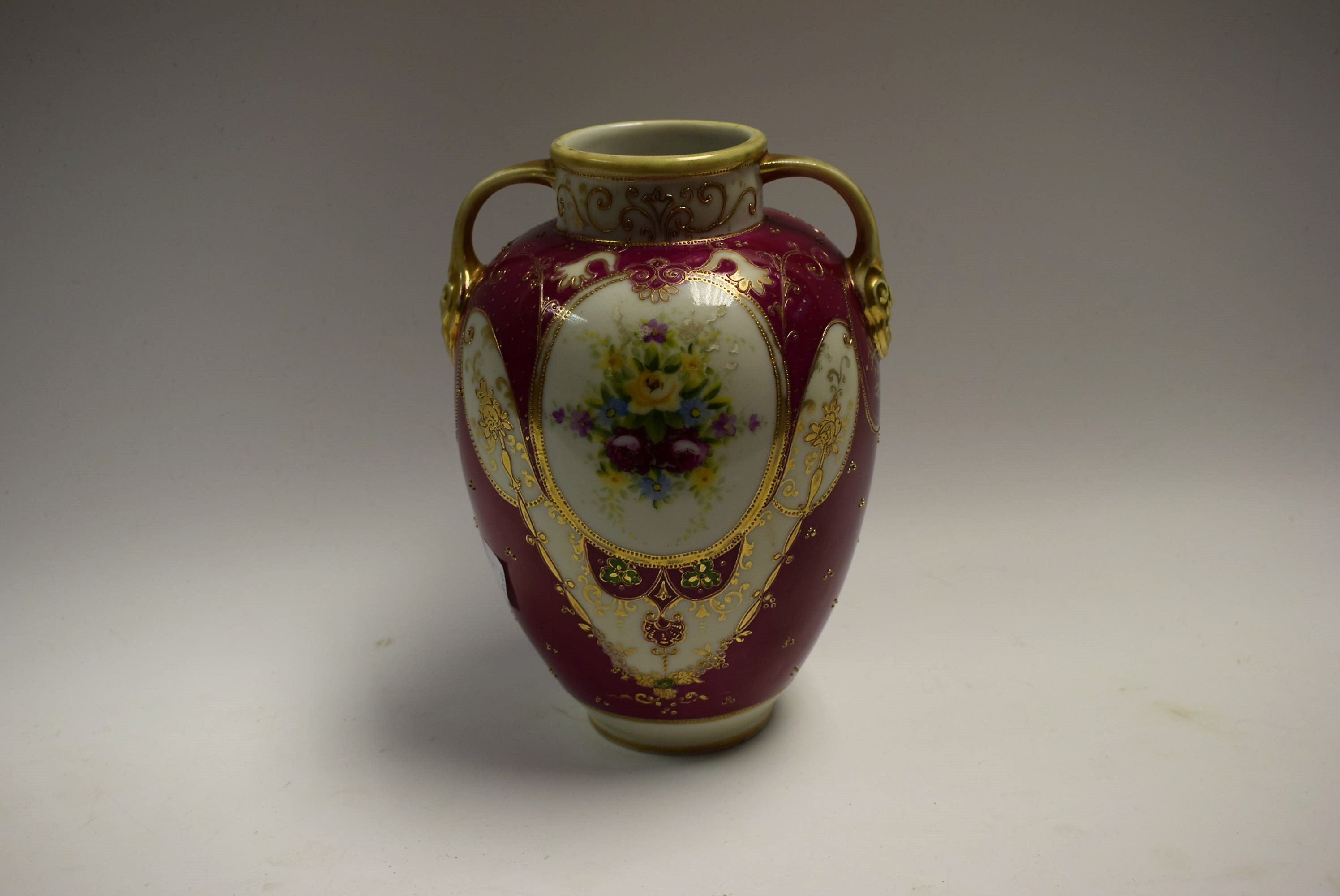 A Noritake twin handled vase, floral decorated, gilt detail, approx.