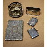 A shaped rectangular silver cigarette case chased and engraved with scrolling foliage,