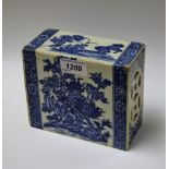 A Chinese opium pillow, each face decorated in underglaze blue with a guardian lion,
