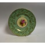A Royal Worcester circular shaped plate, painted by M Millea, signed with pink cabbage roses,
