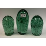 A Victorian green glass dump, organic form bubble inclusions, 18cm high, c.