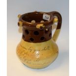 A 19th century slipware motto puzzle jug