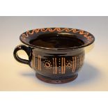 A 19th century style terracotta slipware decorated chamber pot