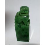 A carved green stone seal stamp, plain matrix, carved fo dog terminal, 7.