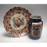 A Japanese shaped circular Imari charger, decorated with flowers in a basket,