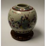 A Chinese ovoid ginger jar, painted with an elder being attended to by young men,