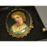 A Victorian painted porcelain brooch.