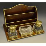 An early 20th century brass mounted mahogany combination inkstand and stationery rack