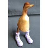 A novelty carved wooden duck, Lilac Boots,