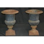 A pair of cast iron campana shaped garden urns