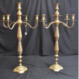 A pair of massive brass floor standing five light candelabra with campana shaped sconces,