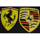 Two reproduction cast iron Porsche and Ferrari wall plaques