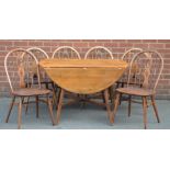 An Ercol drop leaf table and six Ercol chairs