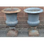 A pair of cast iron urns,