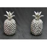 A pair of oversized novelty pineapples, each painted silver, 51cm high, approx.