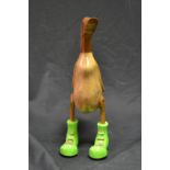 A novelty carved wooden duck, Green Boots,