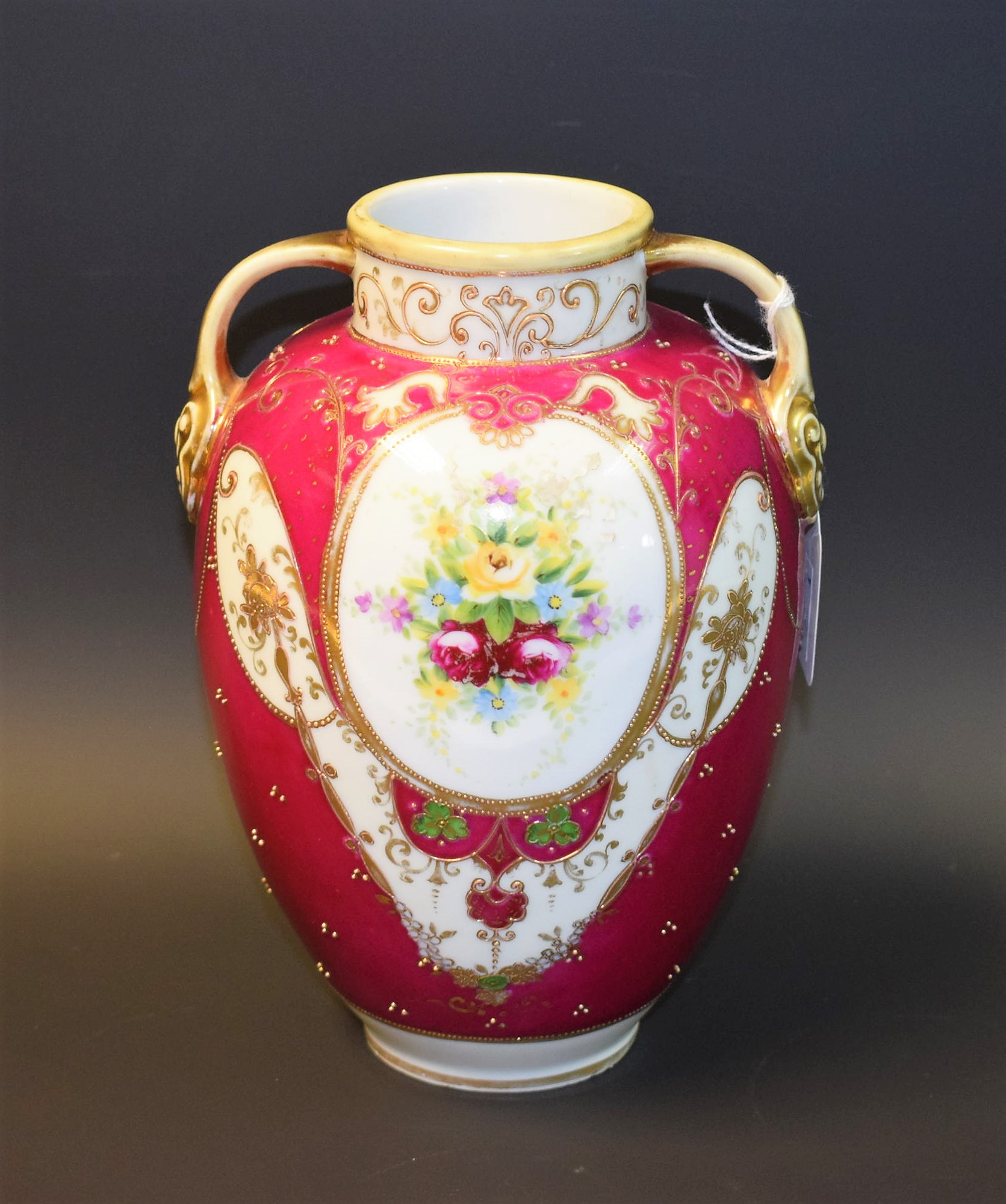 A Noritake twin handled vase, floral decorated, gilt detail, approx.
