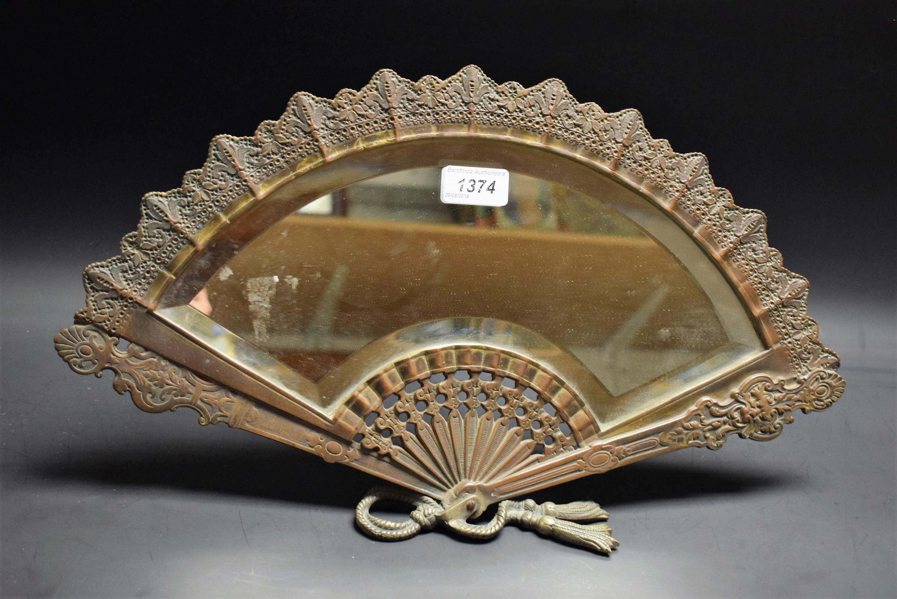 A brass fan shaped dressing table mirror,