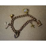 Jewellery - a 9ct rose gold charm bracelet, five 9ct gold and yellow metal charms,