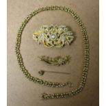 A gold coloured metal chain marked 9ct; brooches;