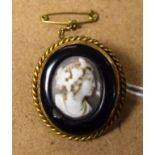 An early 19th century carved cameo brooch, raised profile of a beauty, marked 9ct metal core,