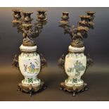 A pair of Chinese bronze and porcelain three light candleabra,