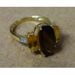 A three stone 9ct gold dress ring