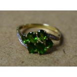 A 9ct gold green tourmaline and diamond cluster ring,
