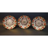 A set of three Royal Crown Derby 1128 pattern shaped circular plates,