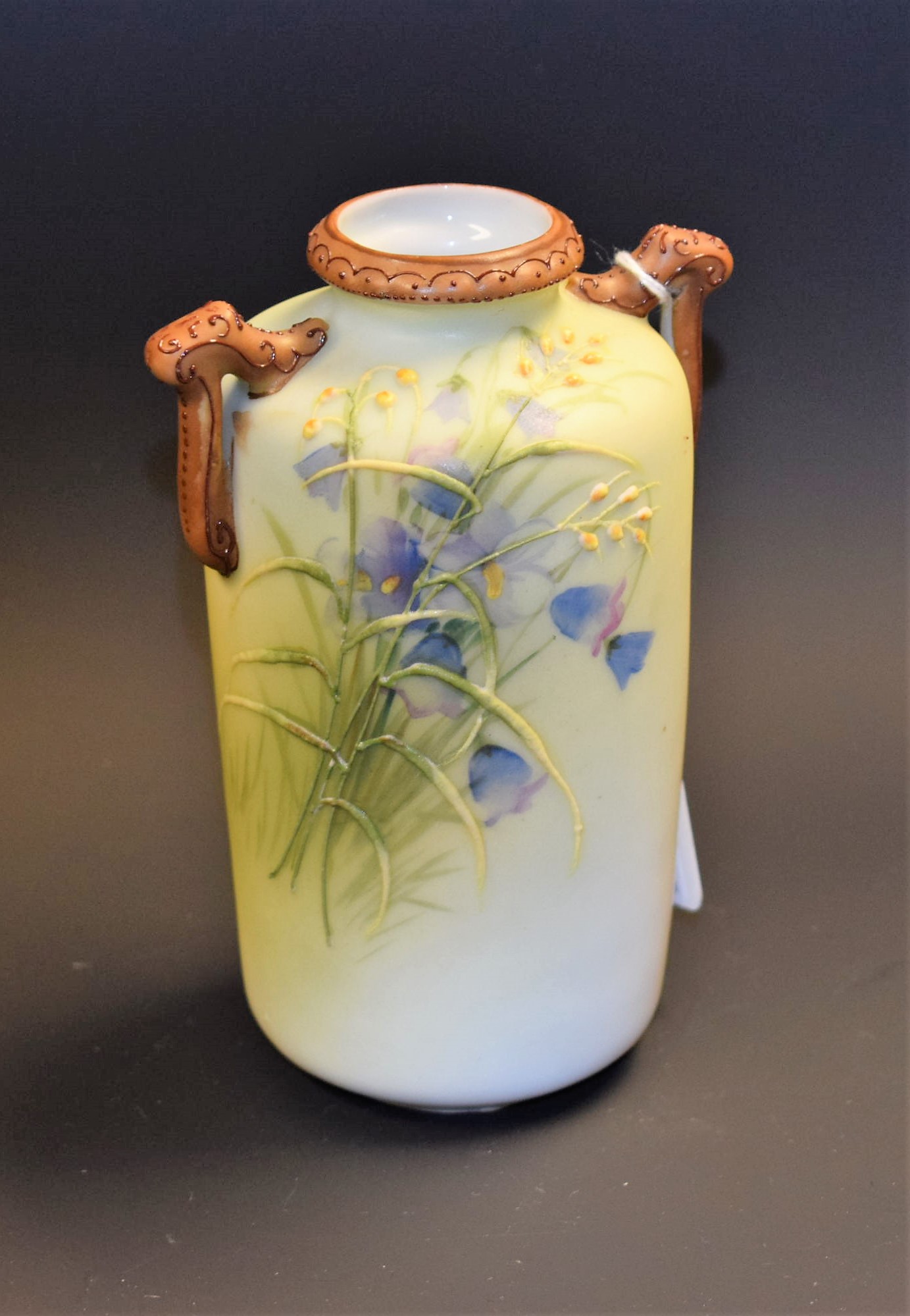 A Noritake two handled vase, decorated with flowers,