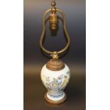 An 18th century Delft baluster lamp, decorated in polychrome with bird, fence, flowers and foliage,
